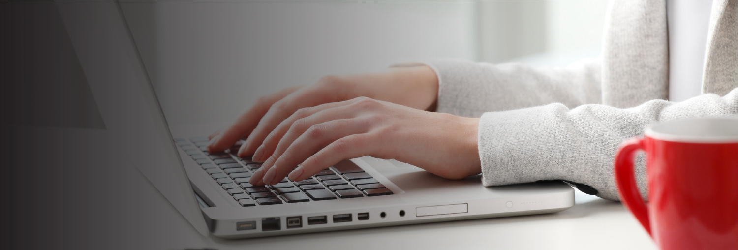 image of hands typing on a laptop